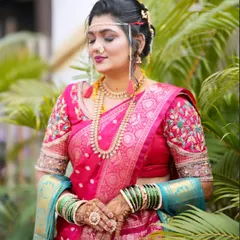 For my Maharashtrian brides, it's all about authenticity. Here, I've paired a classic pink Paithani saree with traditional gold jewellery, a defining nath, and the essential Mundavalya for a truly timeless 'navri' look.