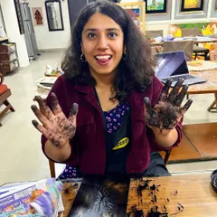Getting your hands dirty is part of the fun. A happy participant shows off her inky hands during a printmaking workshop, a sign of a truly hands-on creative session.