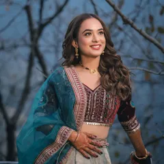 A stunning portrait of a bride-to-be, her happy smile and sparkling eyes captured against a soft, dusky sky.
