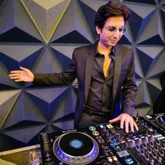 At the console, crafting the perfect musical journey for an incredible birthday party. A great event is all about the details, from the right track selection to reading the crowd's energy.