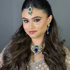 A confident portrait of a North Indian bride, her eyes beautifully defined to match the elegance of her jewelry.