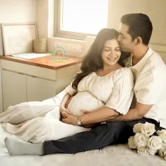 Relaxed and in love, this couple shares a tender moment in their bedroom. Our in-home shoots are designed to be comfortable, allowing for natural interactions and beautiful, authentic portraits.