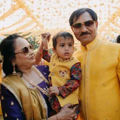 A precious moment with the grandparents. Our little client looks bright and happy in his yellow Bundi set, perfectly dressed for a family wedding's Haldi function.