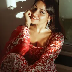 A warm, sun-kissed portrait of actress Symrann K in a beautiful red ethnic outfit. This photo highlights my skill in ethnic glamour photography, using natural light to create a soft and inviting mood.