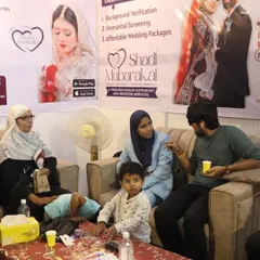 Here I am at a business expo, personally consulting with a family. The banner behind us highlights my core services, including Background Verification and Premarital Screening, which are central to ensuring a secure and transparent match for you.