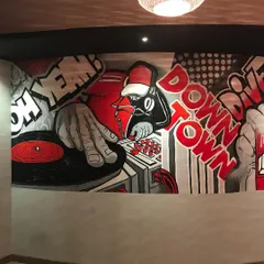 This is the DJ section of the massive pop-art mural I created for Downtown Dive. The design uses a striking red, black, and white color scheme to create a retro comic book feel that matches the bar's lively atmosphere.