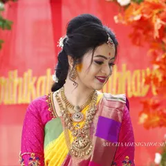 A happy bride is the best review. I loved creating this vibrant pink blouse with detailed embroidery on the sleeves to perfectly complement her multi-colored wedding saree.