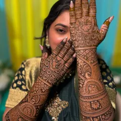 The beautiful bride Rutuja, giving a peek from behind her fully adorned hands. Her joy is palpable.