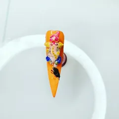 A close-up of the 3D Ganesha nail. I teach how to sculpt small, detailed figures using acrylic powder, making the art truly stand out.