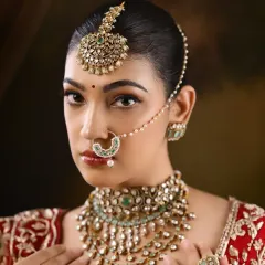 The complete bridal look, showcasing the heavy jewelry and the rich colors of the lehenga. My job is to ensure the makeup stands up to the grandeur of the attire.