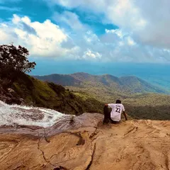 Taking a moment to soak in the vastness from the top of Bandaje Falls. The view of the valley below is just as impressive as the waterfall itself.