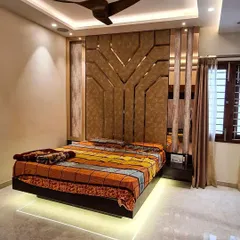 A modern bedroom design centered on a floating bed with white LED under-glow. The headboard wall is a statement piece, featuring a large-scale geometric pattern in suede-finish panels, flanked by vertical mirror strips that add depth.