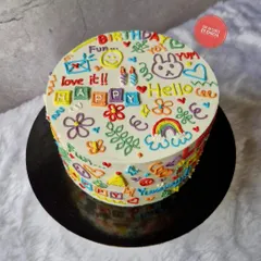 Where creativity meets cake. This playful doodle cake is covered in colorful, hand-piped drawings and messages, making it a fun and unique centerpiece for any celebration. It's a Lotus Biscoff cake inside.