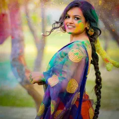 A playful and colorful portrait from a Holi-themed outdoor shoot. The movement of the saree adds a dynamic feel.