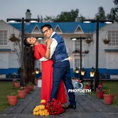 A playful and romantic dip pose in front of a charming blue and white house. This location offers a fantastic backdrop for a variety of pre-wedding shots.