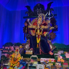 This Ganpati pandal features a large idol with a creative, city-themed miniature model in the foreground. I used blue fabric and lighting to create a night-sky effect for the backdrop.