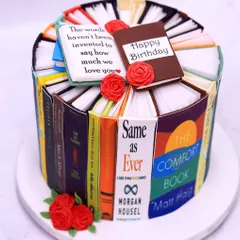 A book lover's dream birthday cake. This design is crafted to look like a stack of beloved books, complete with an open book on top sharing a heartfelt message. Each book spine is a different, recognizable title.