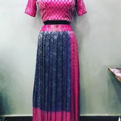 This two-tone lehenga was upcycled from a brocade saree. The pink blouse and blue pleated skirt show how different parts of a saree can be combined.