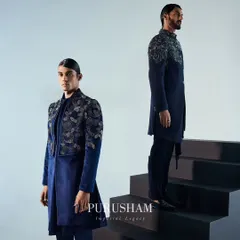 Couture that redefines regal grace. This image showcases two men in my navy blue velvet ensembles, featuring intricate silver embroidery. The designs are a testament to timeless craftsmanship with a modern sensibility.