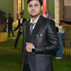A portrait of a guest looking sharp in a three-piece suit at an outdoor event.
