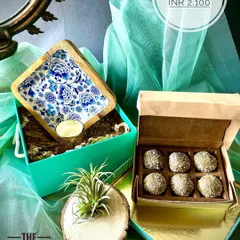 I love how this hamper turned out. The star is the beautiful square platter with its intricate blue and white enamel work, paired with a box of delicious upcycled sweets. We added a little botanical friend, an air plant, nestled in a rustic wood holder to bring a touch of green life to your home.
