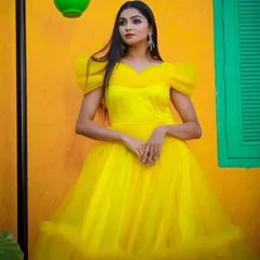 This shot captures the vibrant color and dreamy texture of the yellow gown, perfect for creating fairytale moments.