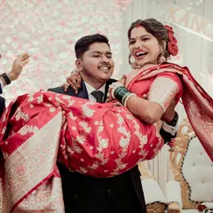 A moment of pure, unscripted joy. The groom lifts his bride, and her laughter fills the room. We live for capturing these candid reception memories.