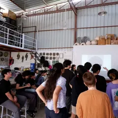 A group of students gathered around for a demonstration. Sharing knowledge and seeing the spark of understanding is one of the best parts of teaching.