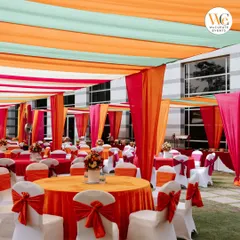 I love working with color to create a festive atmosphere. For this outdoor Mehendi, we used vibrant orange, pink, and mint drapes to create a cheerful canopy, setting the perfect mood for a daytime celebration.