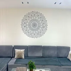 Here is how a custom mandala mural can become the soul of a living room. This piece was designed to bring a sense of calm and balance, perfectly complementing the modern grey sofa and minimalist decor.