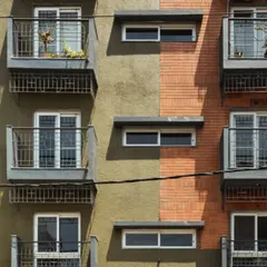 The facade of the Pixel 2 apartment building is a nod to Bengaluru's identity. We used locally sourced red bricks reminiscent of colonial architecture and a textured green plaster inspired by the "Garden City" tag. Each unit features a balcony with grills inspired by old bungalow gates, blending nostalgia with modern design.