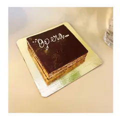 My classic Opera Cake, presented in its traditional square form. It's an elegant and irresistible dessert, sure to captivate your senses with every heavenly bite.