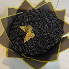 For a love that's bold and timeless, I crafted this bouquet of 100 sparkling black satin roses. These forever flowers make a dramatic statement and last as a keepsake, complete with a delicate golden butterfly accent.