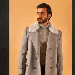 A closer look at our grey overcoat, this time with a faux fur collar for added warmth and luxury. It's a sophisticated piece for the discerning gentleman.