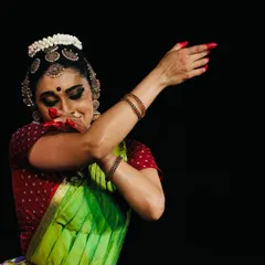 A moment of shy joy, a glance away from the audience, capturing the subtle emotions that abhinaya can convey.