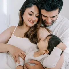 The best photos often happen when they are unposed and unplanned. This intimate family cuddle on the bed is a perfect example of capturing natural love and connection.