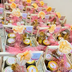 A sea of pink and yellow for a joyous Haldi celebration. These wooden baskets are filled with jars of snacks and treats, each personalized for the event.