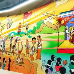 Another view of the IT company mural, this time showing a Yakshagana performance on stage and a lively depiction of the Pilivesha (tiger dance). This artwork serves as a cultural anchor within a corporate environment.
