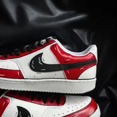 A close-up of the red cartoon custom sneaker, showing the sketch-like details on the swoosh.
