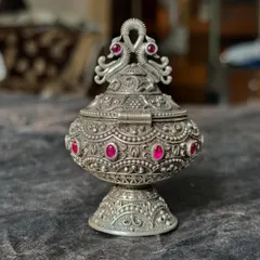 Another angle of our stunning silver kumkum box. The detailed engraving and the vibrant pink stones make it a decorative piece as well as a functional pooja item.