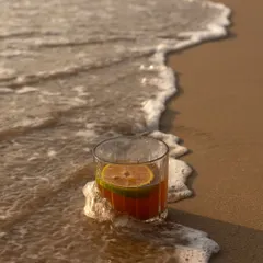 There's something so calming about a drink by the sea. I captured this cocktail as the waves gently washed over it, creating a serene and beautiful beach lifestyle shot.