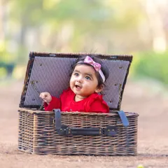 A perfect little surprise. Props like this picnic basket add a touch of playfulness to the session while keeping the baby safely and adorably contained.