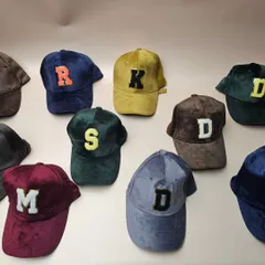 A lineup of our custom initial suede caps in various colors. You can choose your favorite color and initial to create your own unique look.