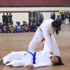 This is what practical application looks like. Our students demonstrate effective ground-based self-defense techniques during a competitive event, showcasing the skills learned in our karate and self-defense programs.