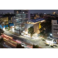 An aerial view at night shows MAP as a beacon in Bengaluru's museum quarter, its illuminated form contributing to the city's vibrant cultural life.