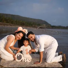 A family's first portrait, complete with sandy toes and ocean breezes. I adore taking my sessions outdoors to capture beautiful, natural light and create authentic moments like this first birthday celebration by the sea.
