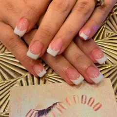 A classic French manicure on short, square-shaped nails. This is a clean, professional, and timeless look that is perfect for everyday wear.