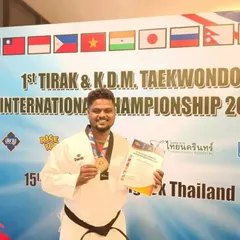 Holding my certificate and bronze medal at the international Taekwondo championship in Thailand. This achievement represents our academy's commitment to performing on the world stage.