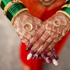 A symbol of forever. A close-up of the engagement rings resting on the bride's beautifully decorated hands.