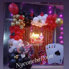 I designed this fun photo corner for a Diwali card party. It features a red and gold sequin backdrop, a "Happy Diwali" neon sign, and casino-themed props like giant playing cards and dice, all framed by a stylish balloon arch.